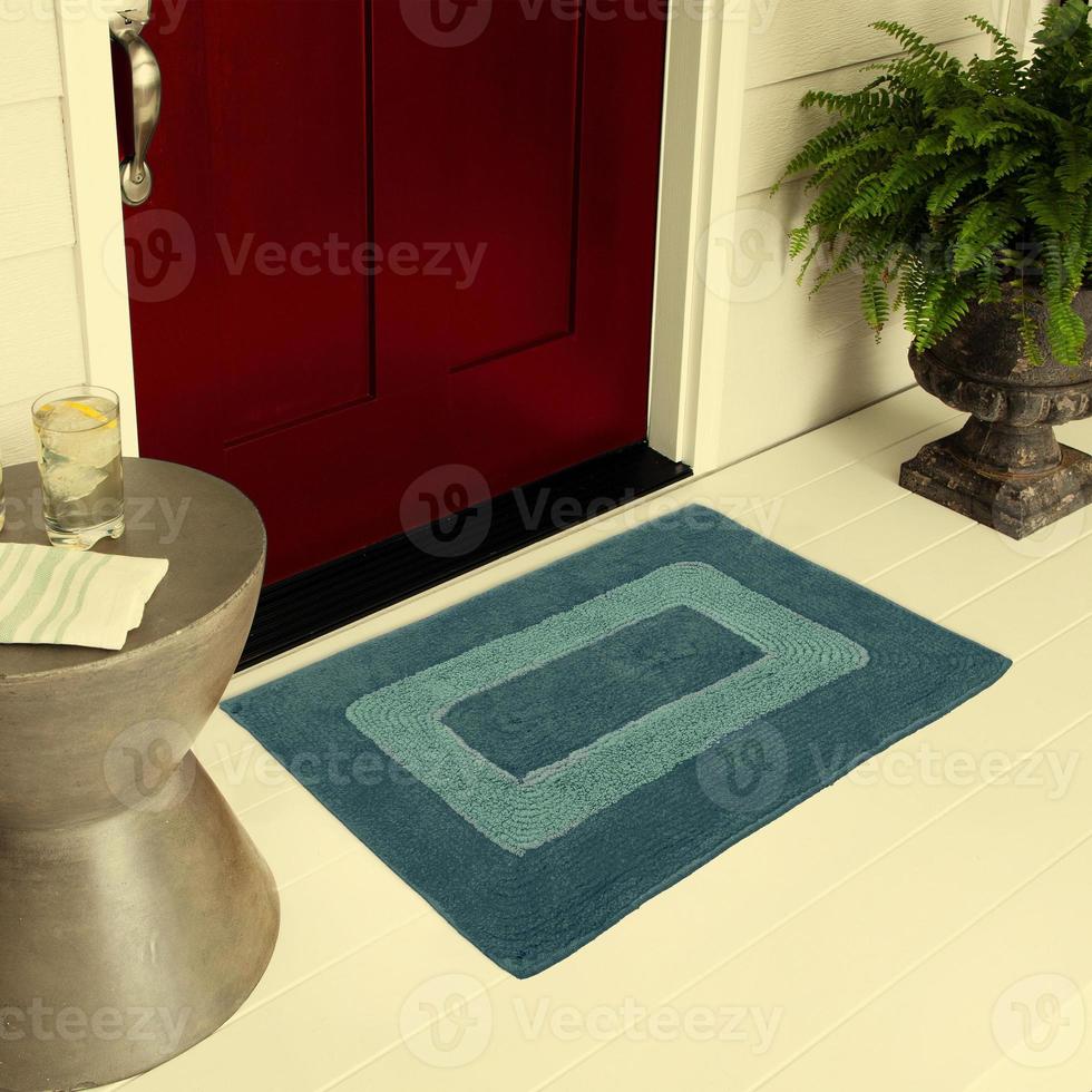 Designer Welcome Entry Doormat Placed on Floor Outside Entry Door with Plants and lemon ice drink photo