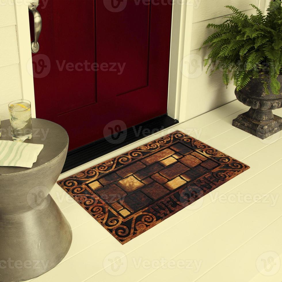 Designer Welcome Entry Doormat Placed on Floor Outside Entry Door with Plants and lemon ice drink photo