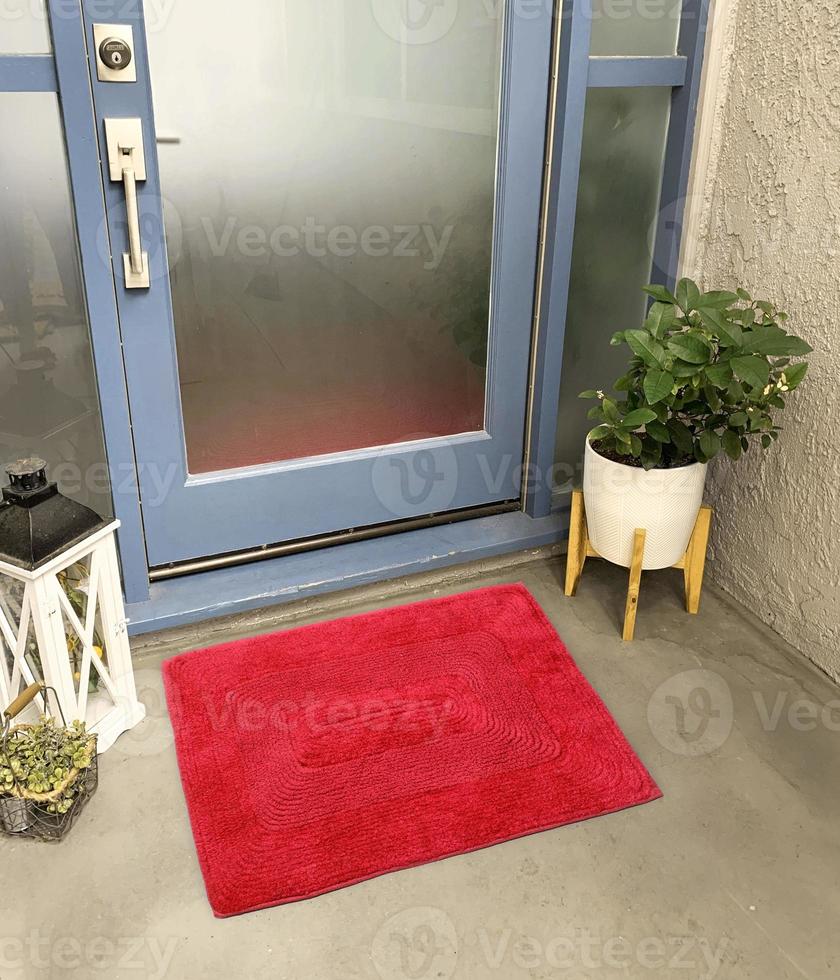Designer Welcome Entry Doormat Placed Outside Entry Door with Plant and Lamp photo