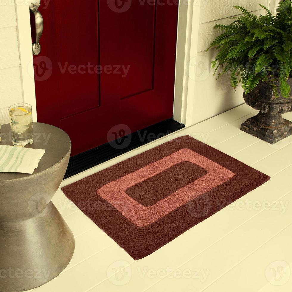 Designer Welcome Entry Doormat Placed on Floor Outside Entry Door with Plants and lemon ice drink photo