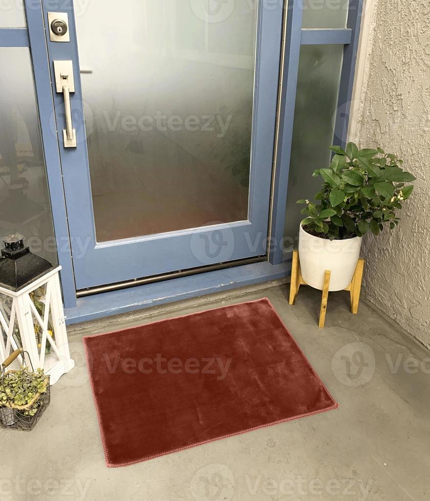 Designer Welcome Entry Doormat Placed Outside Entry Door with Plant and Lamp photo