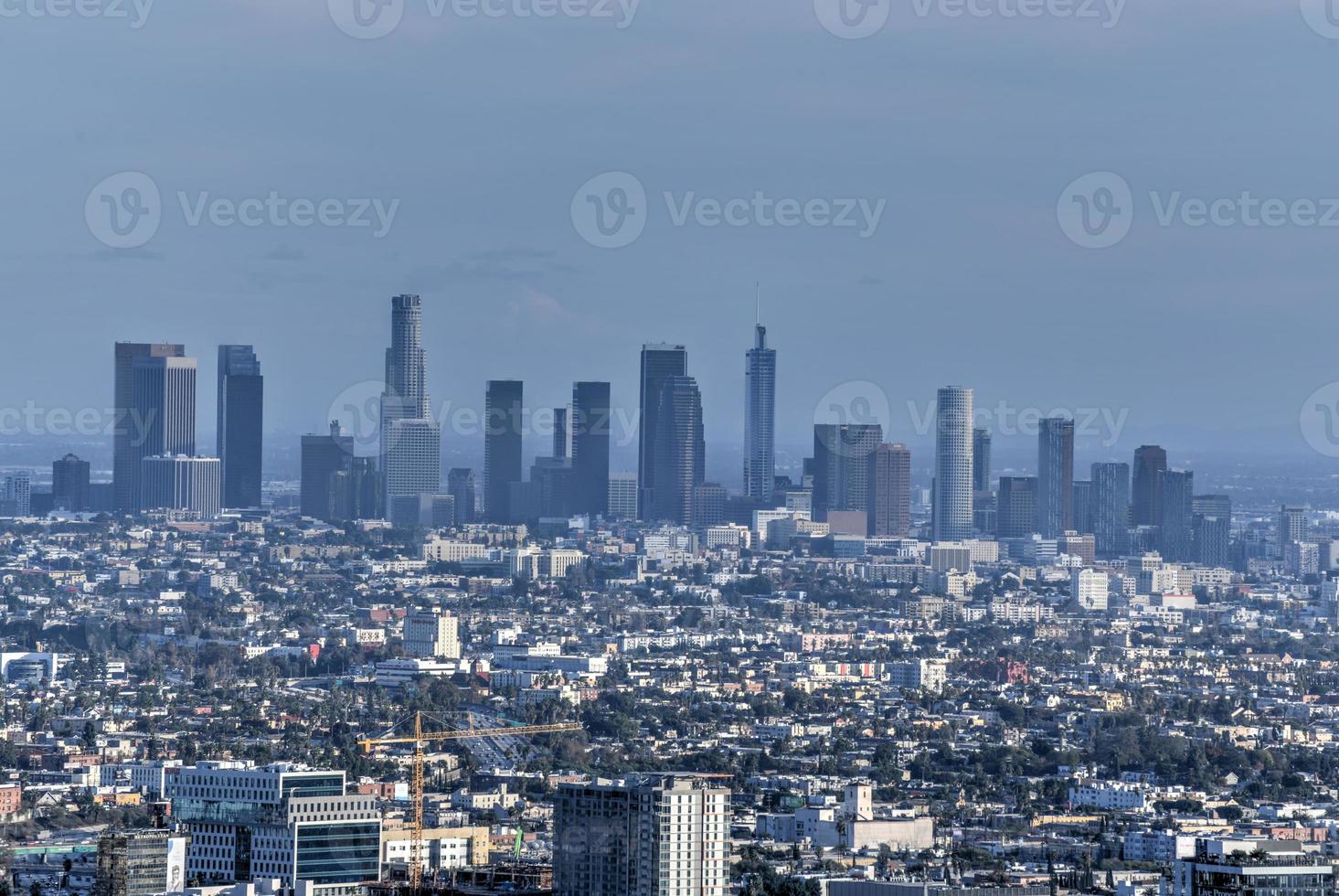 Downtown Los Angeles skyline over blue cloudy sky in California from Hollywood Hills. photo
