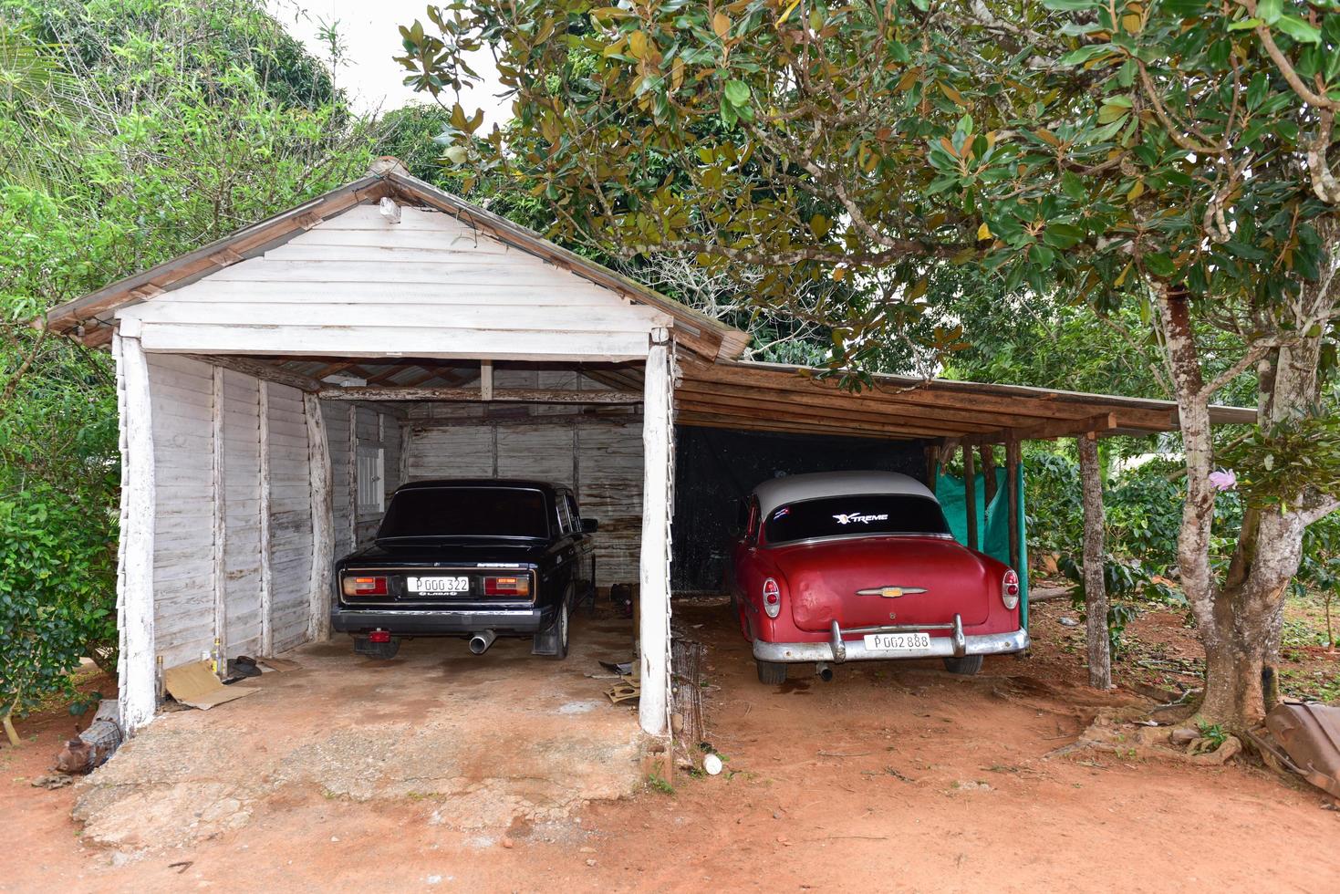 Vinales, Cuba - January 9, 2017 -  Russian Lada and American classic car in a garage in the Vinales valley, north of Cuba. photo