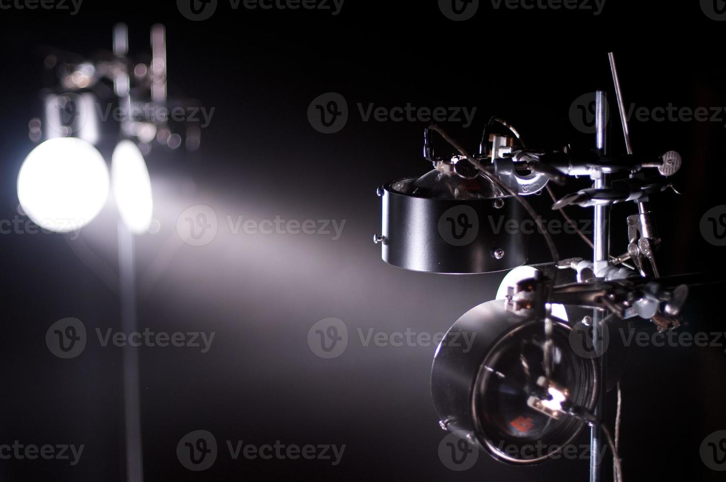 Display of lights reflecting between mirrors in a dark room. photo