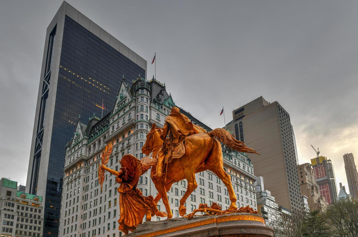 Golden statue of General William Tecumseh Sherman in Central Park, New York with buildings in background, 2022 photo