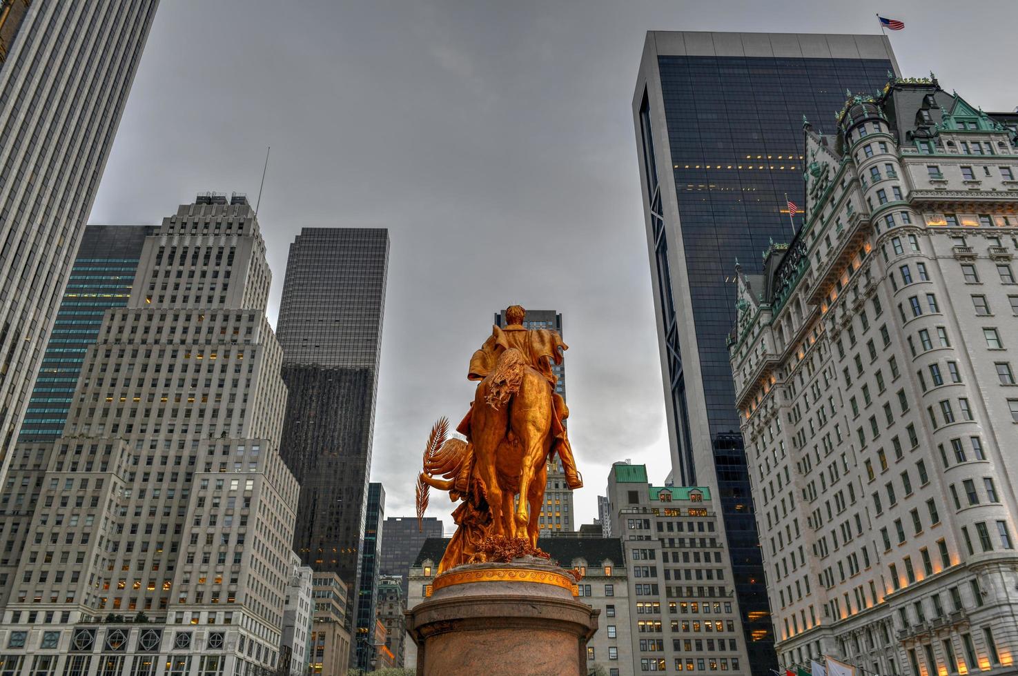 Golden statue of General William Tecumseh Sherman in Central Park, New York with buildings in background, 2022 photo