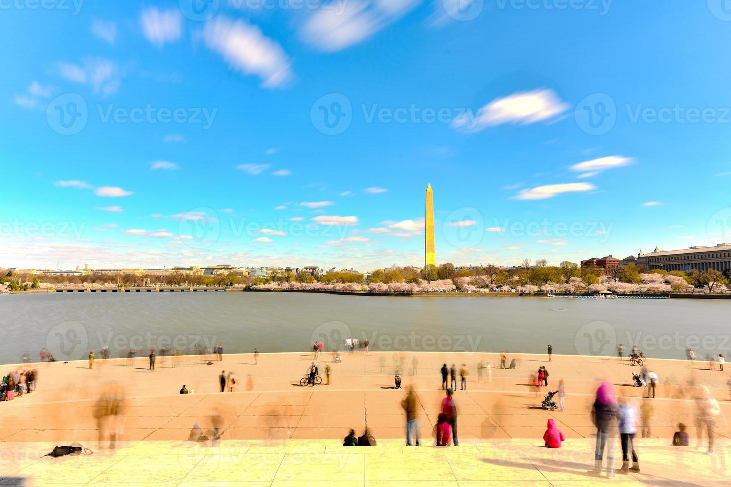 Tourists in front of the Jefferson Memorial looking out at the Washington Monument and cherry blossoms at the Tidal Basin during spring in Washington, DC. photo