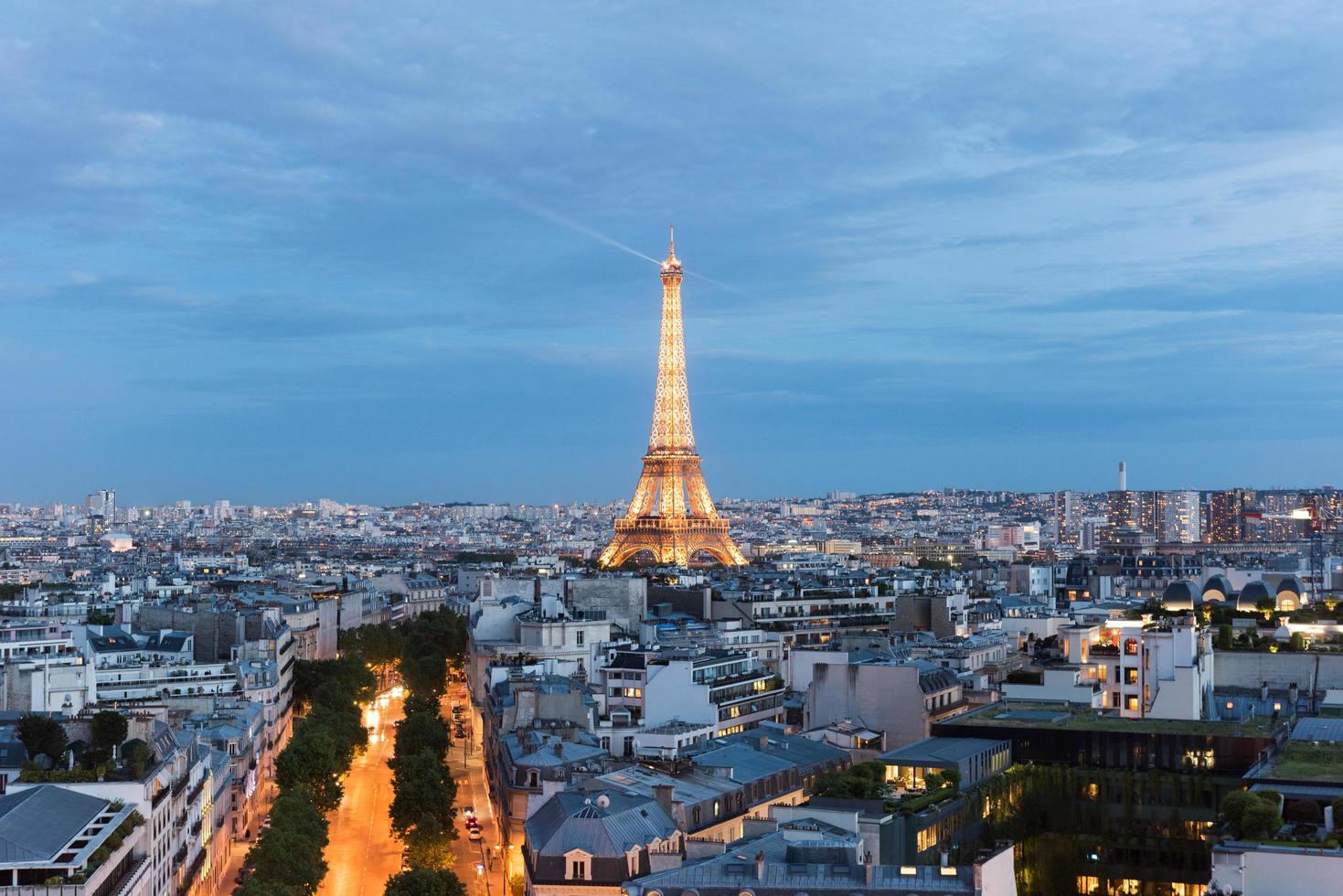 View of the the Eiffel Tower and the Paris city skyline into the distance at dusk, 2022 photo