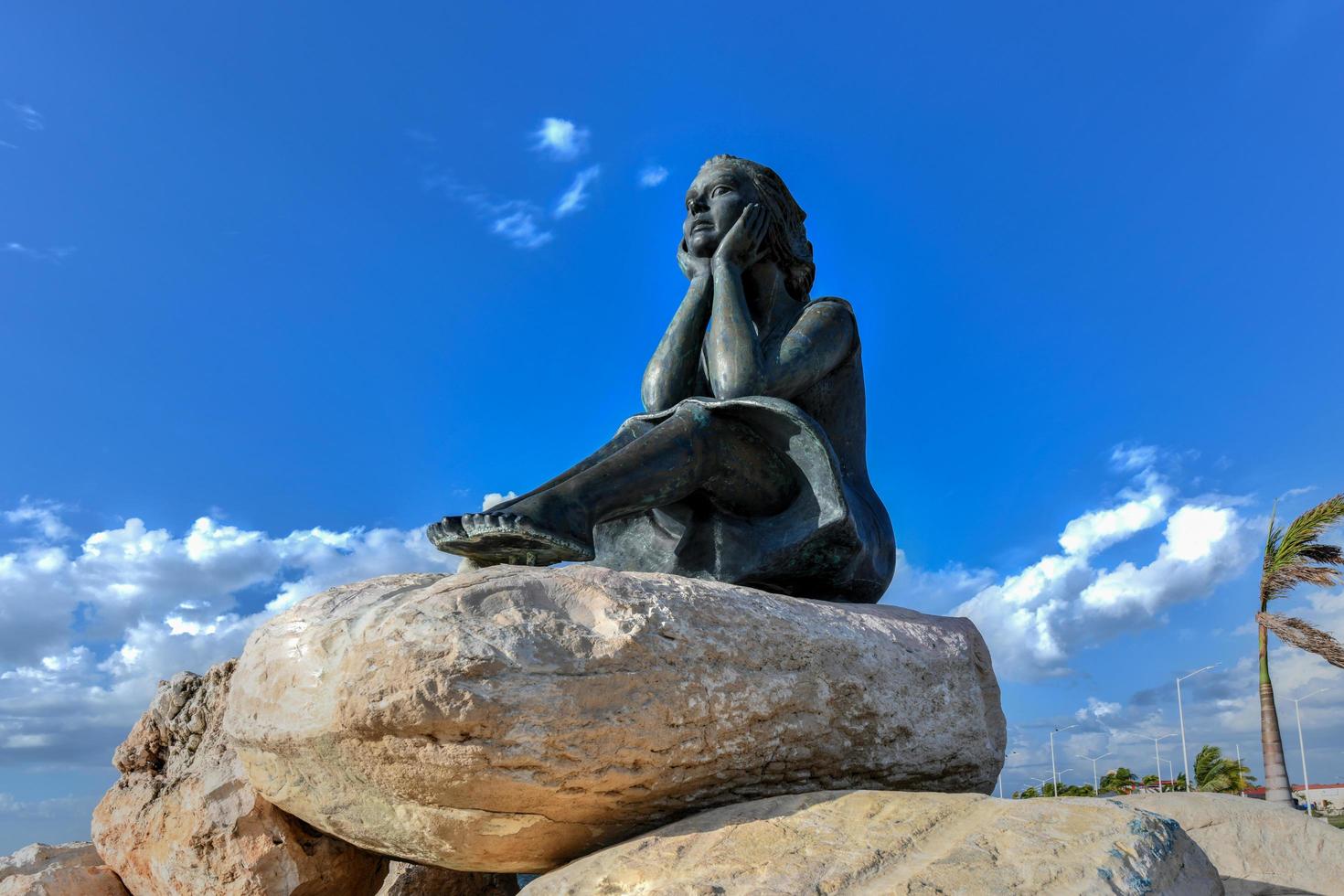 Campeche, Mexico - May 25, 2021 -  Statue of girl known as Bride of the Sea looking at sea on Malecon in center of Campeche, beautiful historic colonial city in Yucatan, Mexico on sunny day. photo