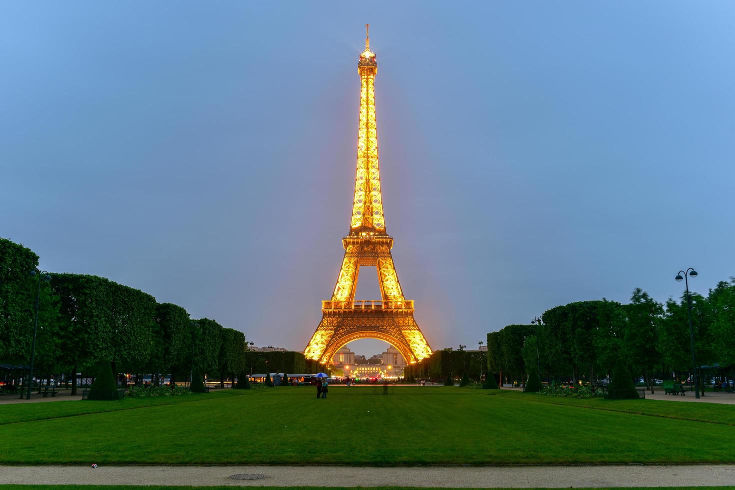 The iconic Eiffel Tower on a drizzly evening from the Champ de Mars in Paris, France, 2022 photo
