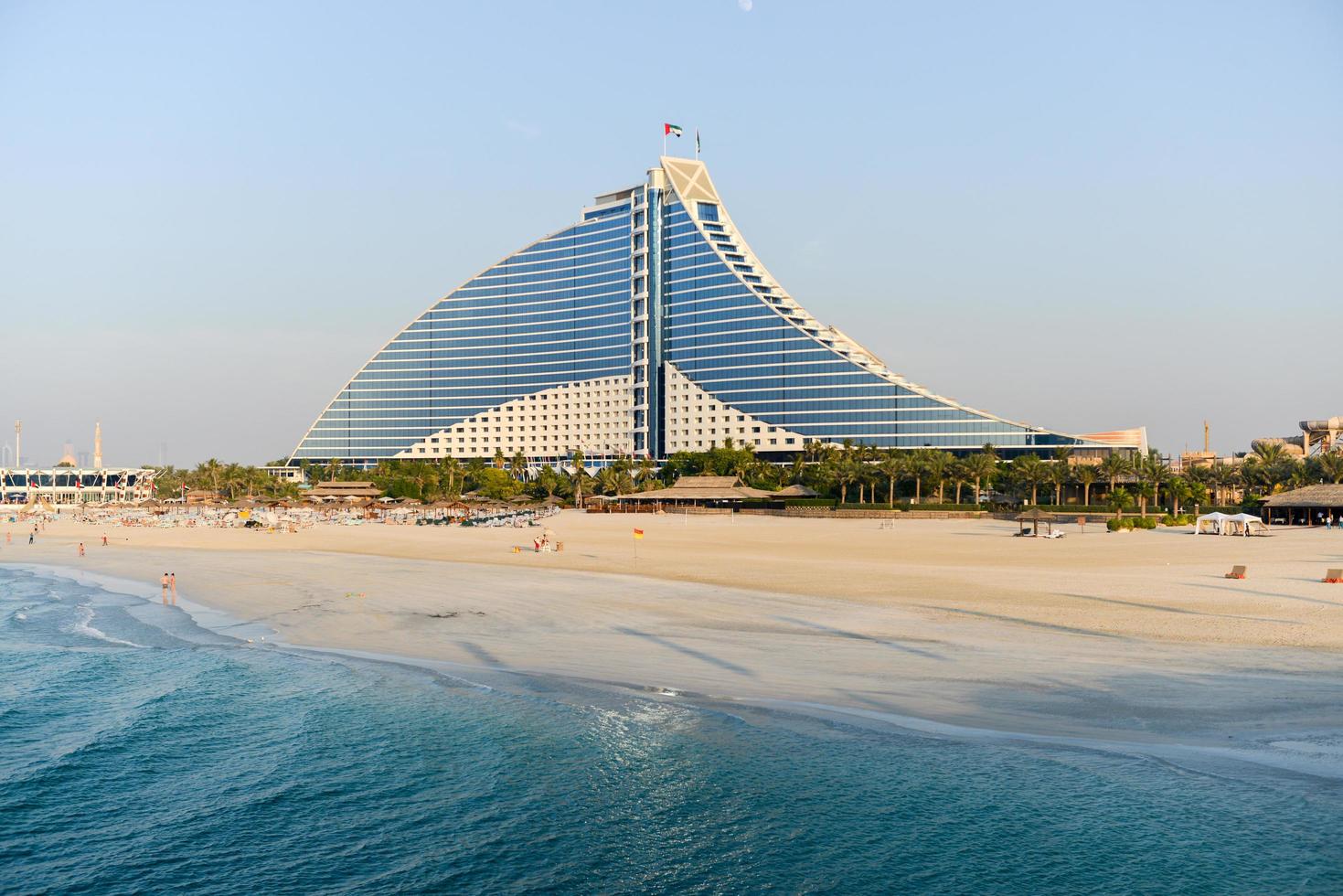 Dubai, UAE - November 25, 2012 -  Jumeirah Beach Hotel in Dubai. This wave-shaped hotel complements the sail-shaped Burj Al Arab, which is adjacent to the Jumeirah Beach Hotel. photo