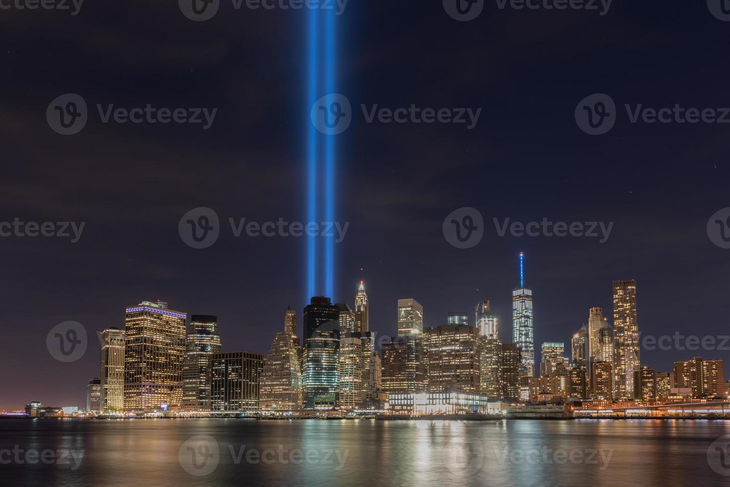 New York City Manhattan downtown skyline at night with the Tribute in Light in memory of September 11. photo