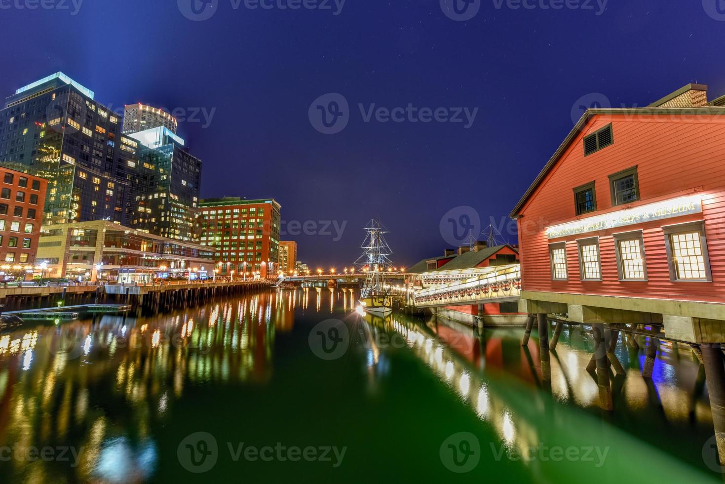 The Boston Tea Party Museum, in Boston Harbor in Massachusetts, USA with its mix of modern and historic architecture at night. photo