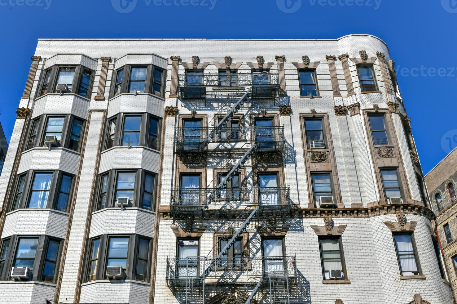 View of old apartment buildings and fire escapes in New York City photo