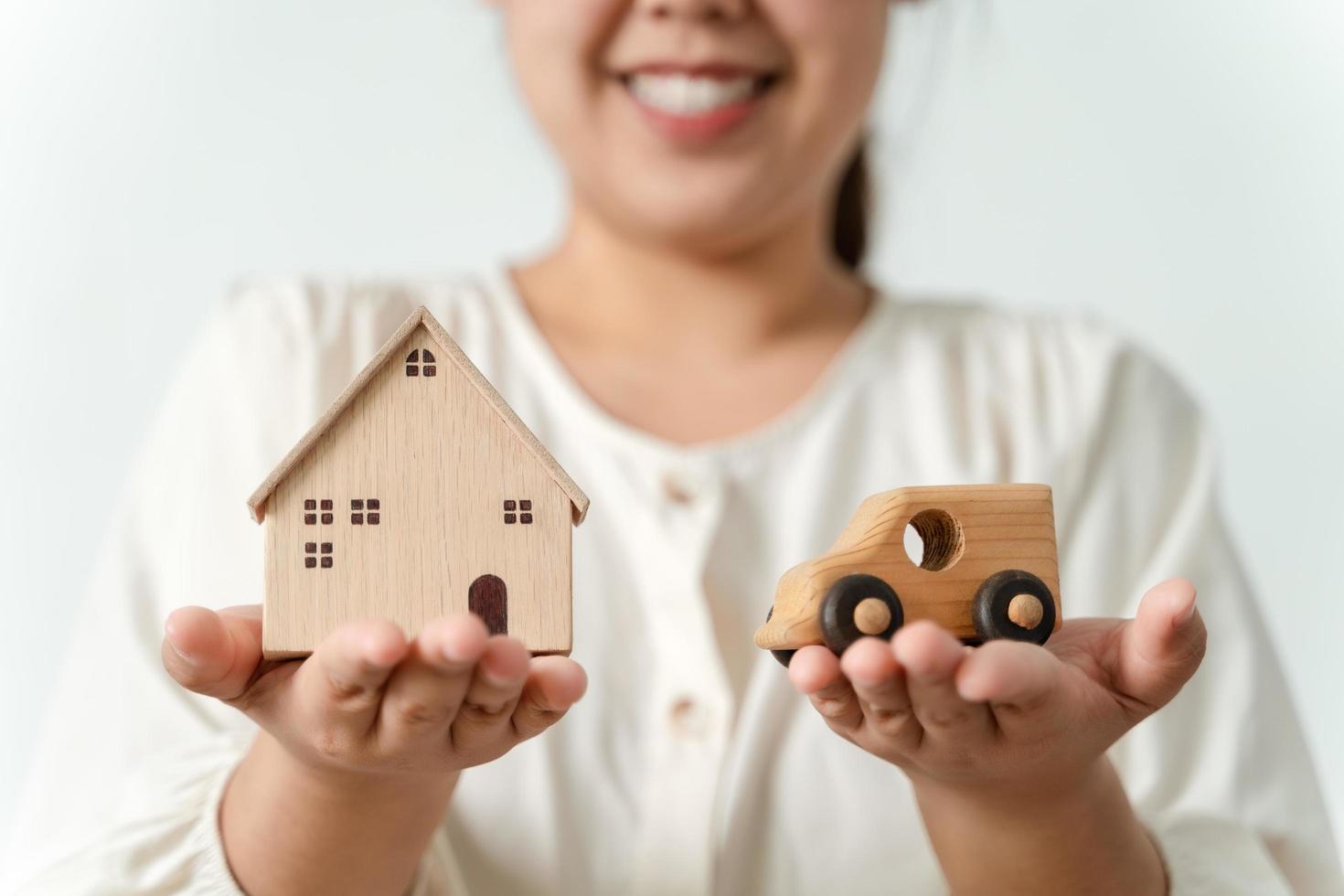 confused Asian woman buyer choosing between buying new home or car. photo