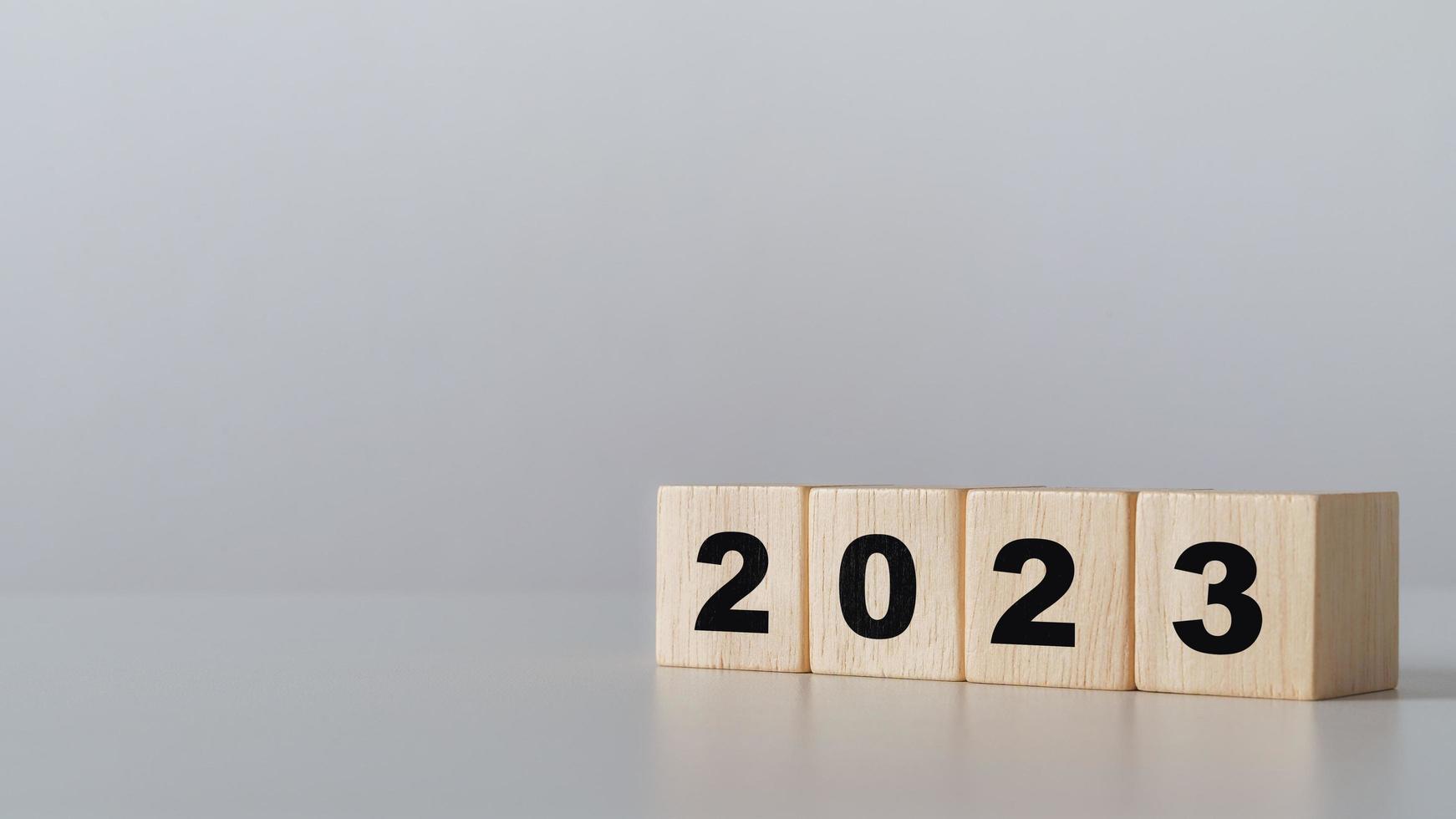 start to year 2022. wooden cube block with 2023 year text. happy new years concept. photo