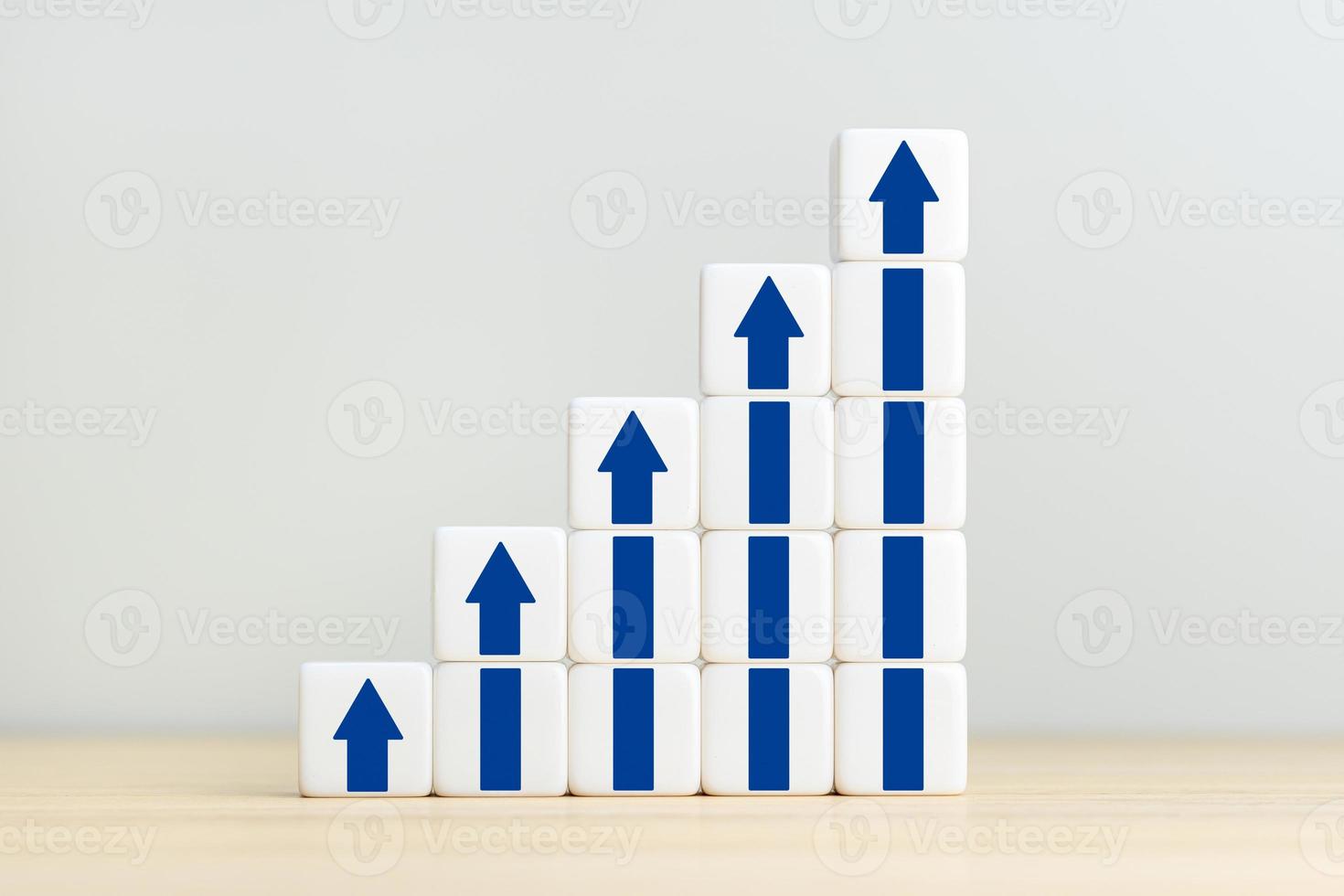 Stacked cube blocks with blue up arrows. Growth, increase of business and economy. Copy space photo