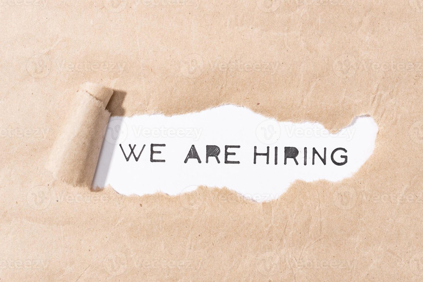 We are Hiring message on torn paper photo