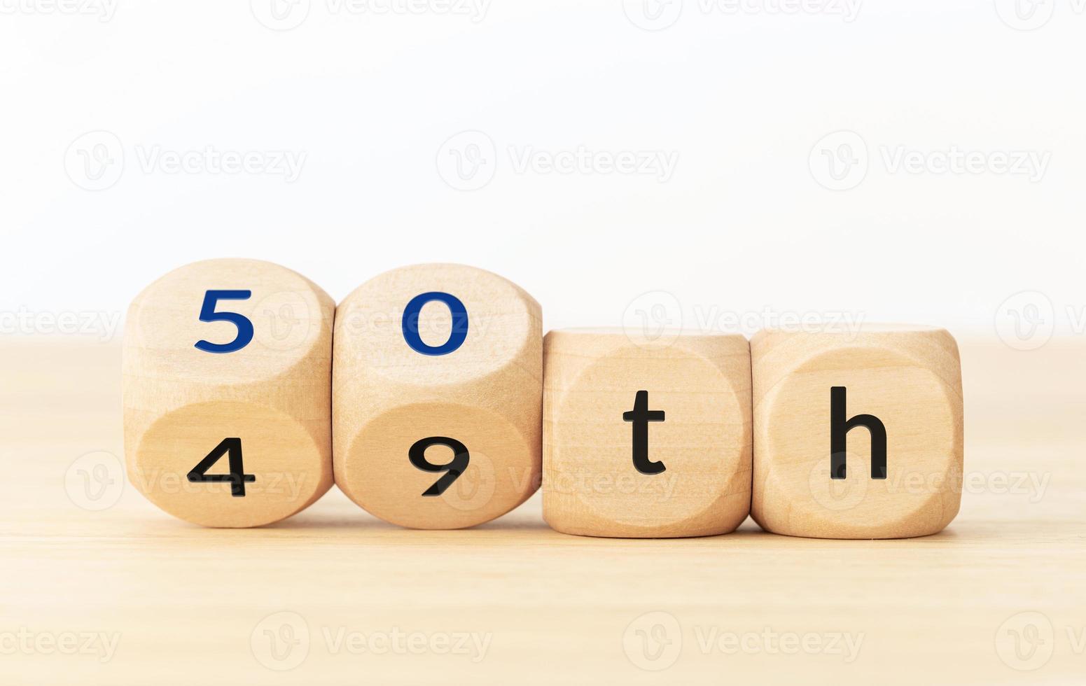 Turning 50 years old concept. Text on wooden blocks and changing dices photo