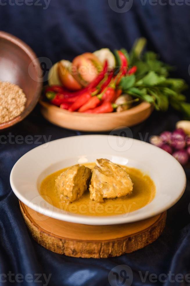 Rendang Ayam or Chicken Rendang, is an Indonesian food from West Sumatra in Indonesia. Chicken Rendang served on plate photo