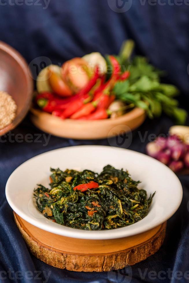 Stir fry Papaya Leaves or Tumis Daun Pepaya with Spice and Chill. indonesia foodi photo