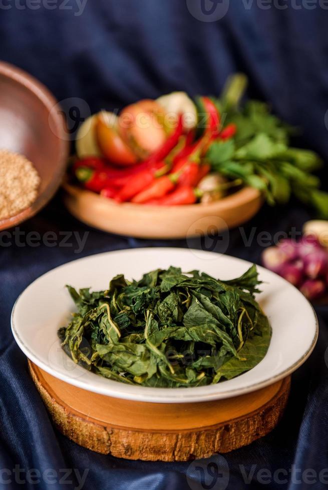 stir fry cassava leaves on dish. indonesia food photo