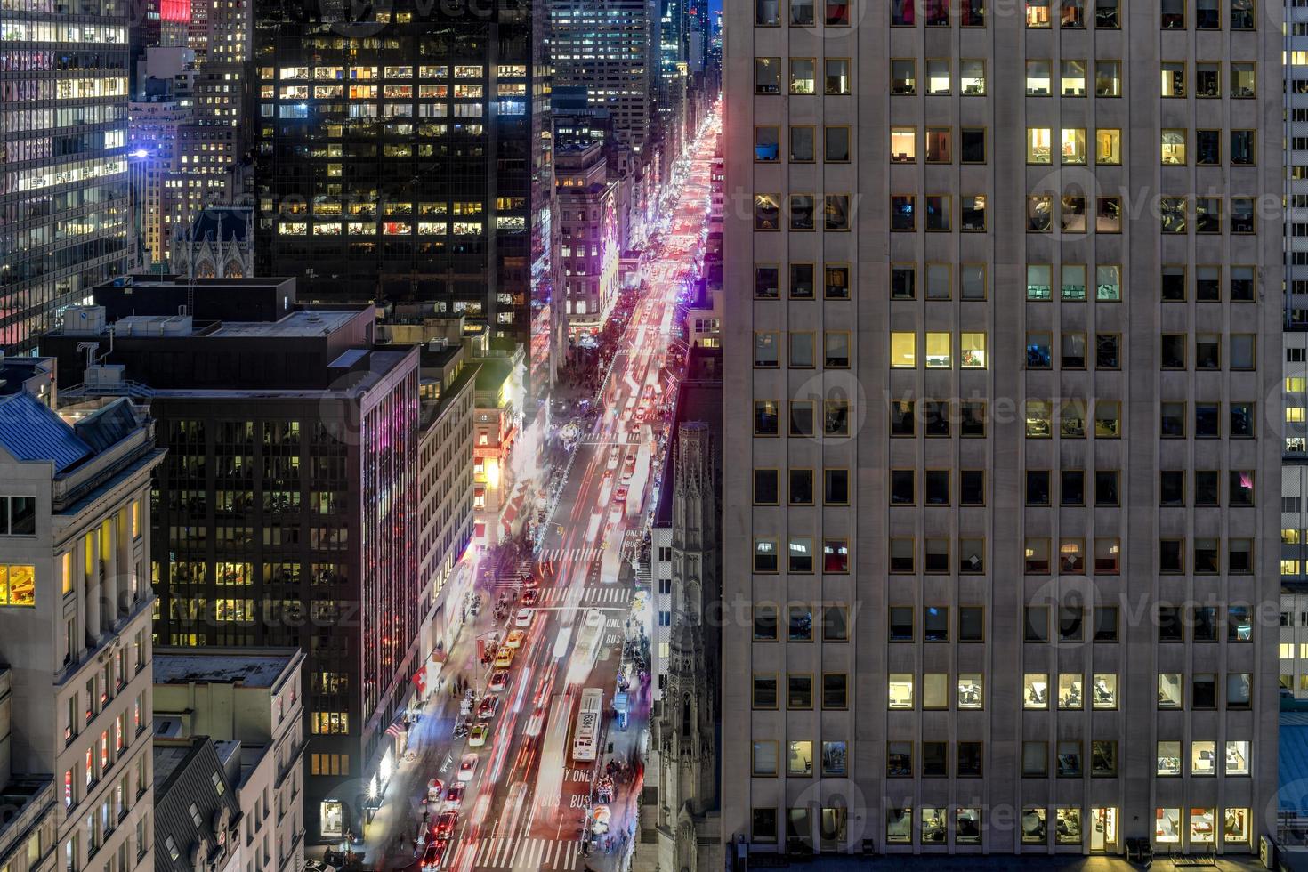 New York City skyline in midtown Manhattan as cars drive through the city in the evening. photo