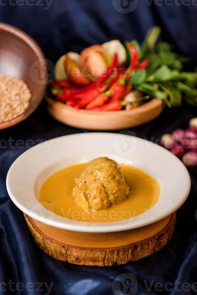 Rendang Ayam or Chicken Rendang, is an Indonesian food from West Sumatra in Indonesia. Chicken Rendang served on plate photo