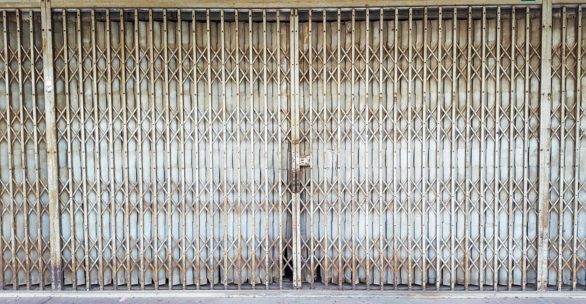 Old rusty silver traditional foldable metal door photo