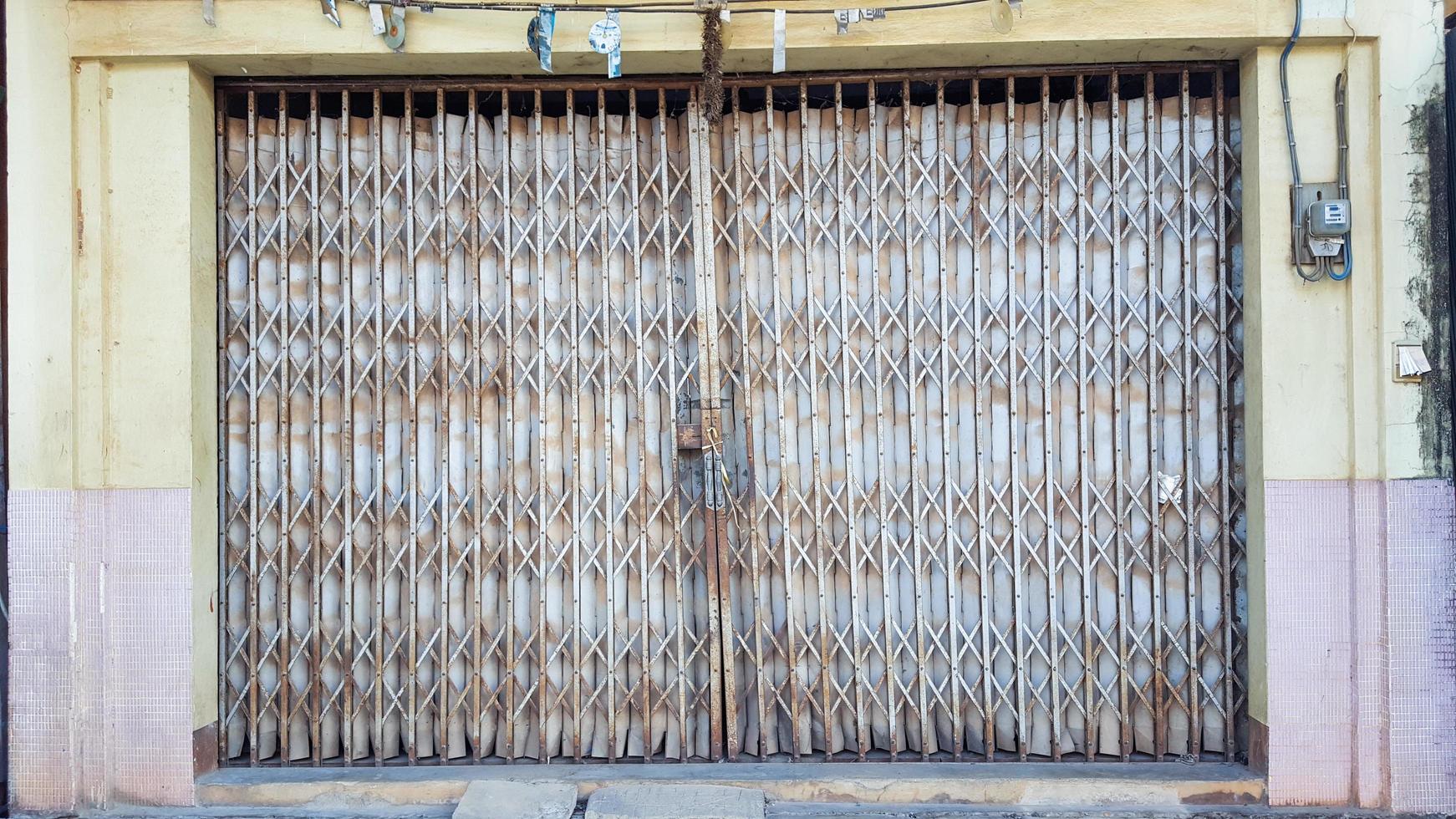 Old rusty silver traditional foldable metal door photo