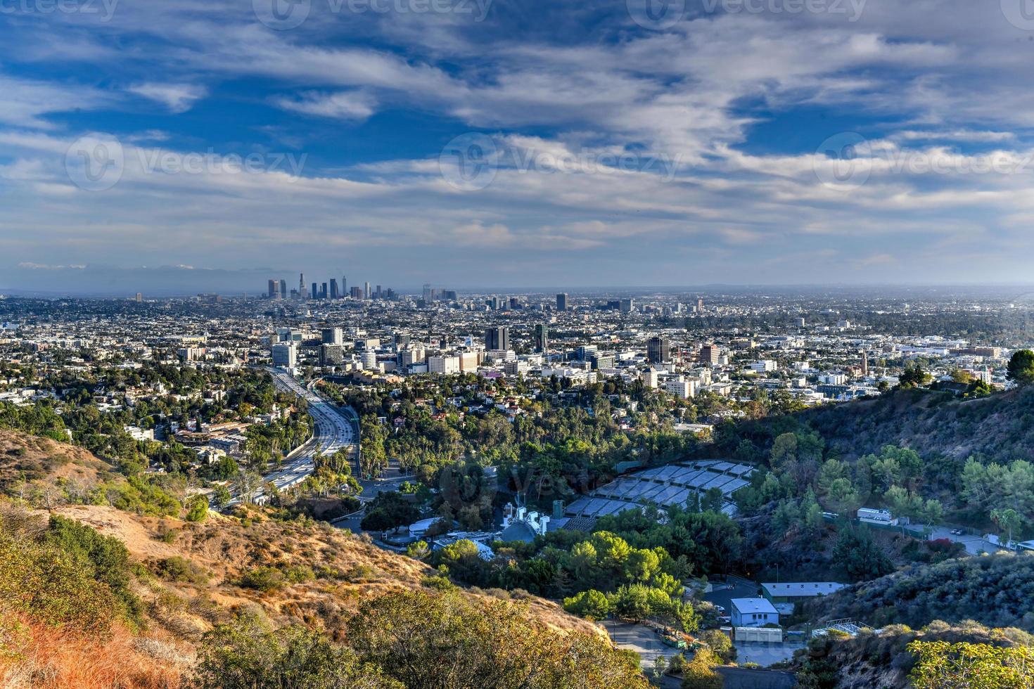 Downtown Los Angeles skyline over blue cloudy sky in California from Hollywood Hills. photo