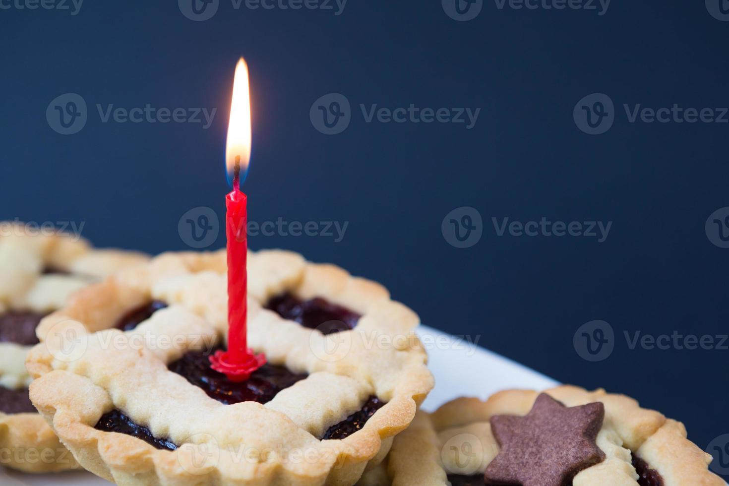 Sweet cake with burning candle photo