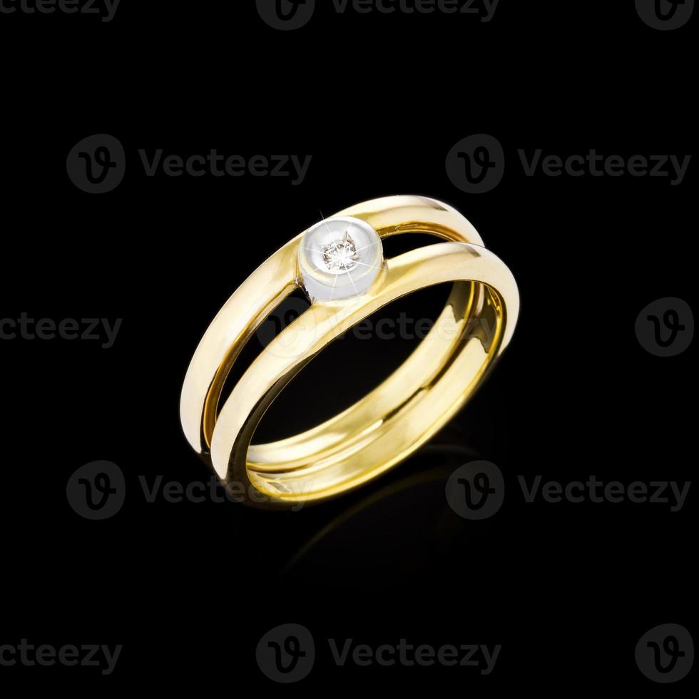 Golden diamond ring on black background photo