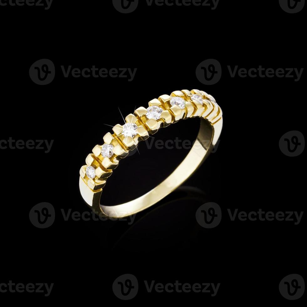 Golden diamond ring on black background photo