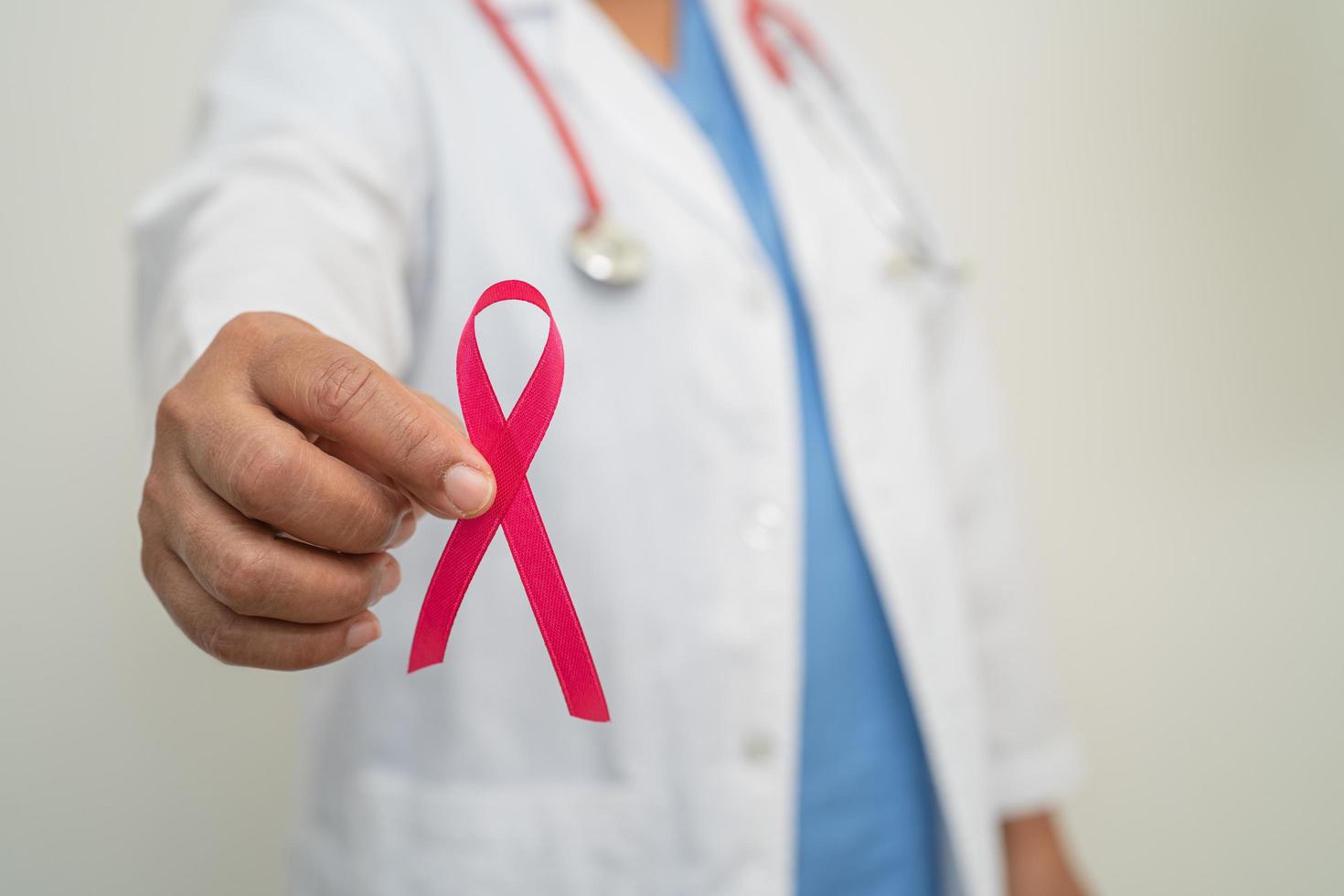 Breast cancer, Asian doctor woman with pink ribbon, symbol of World Breast Cancer Day. photo