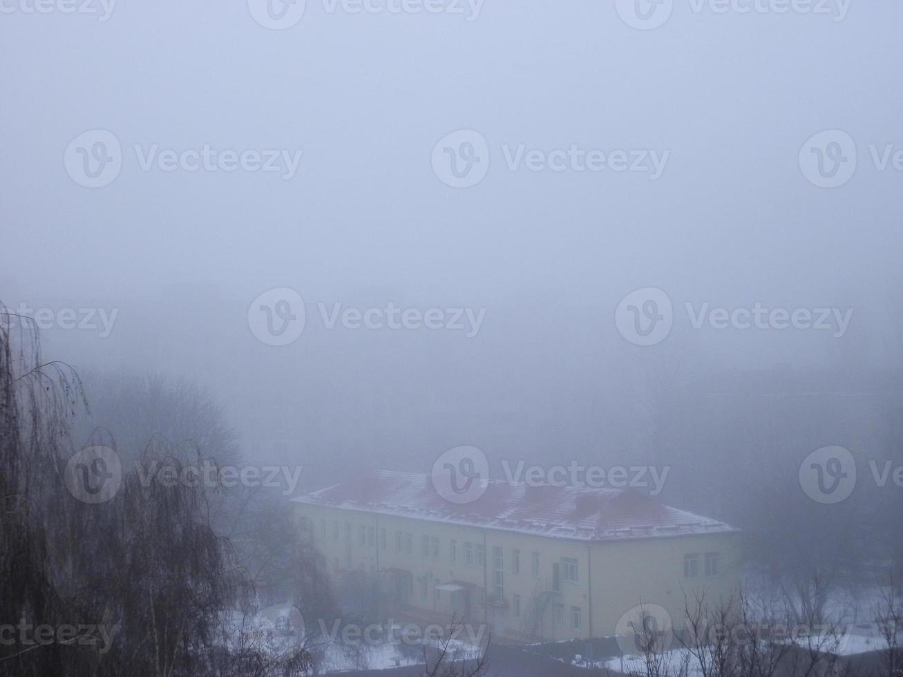 Morning winter fog in a big city photo