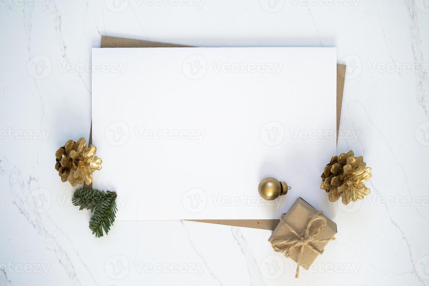 Mockup for a letter or a Christmas invitation with gold fir cone photo