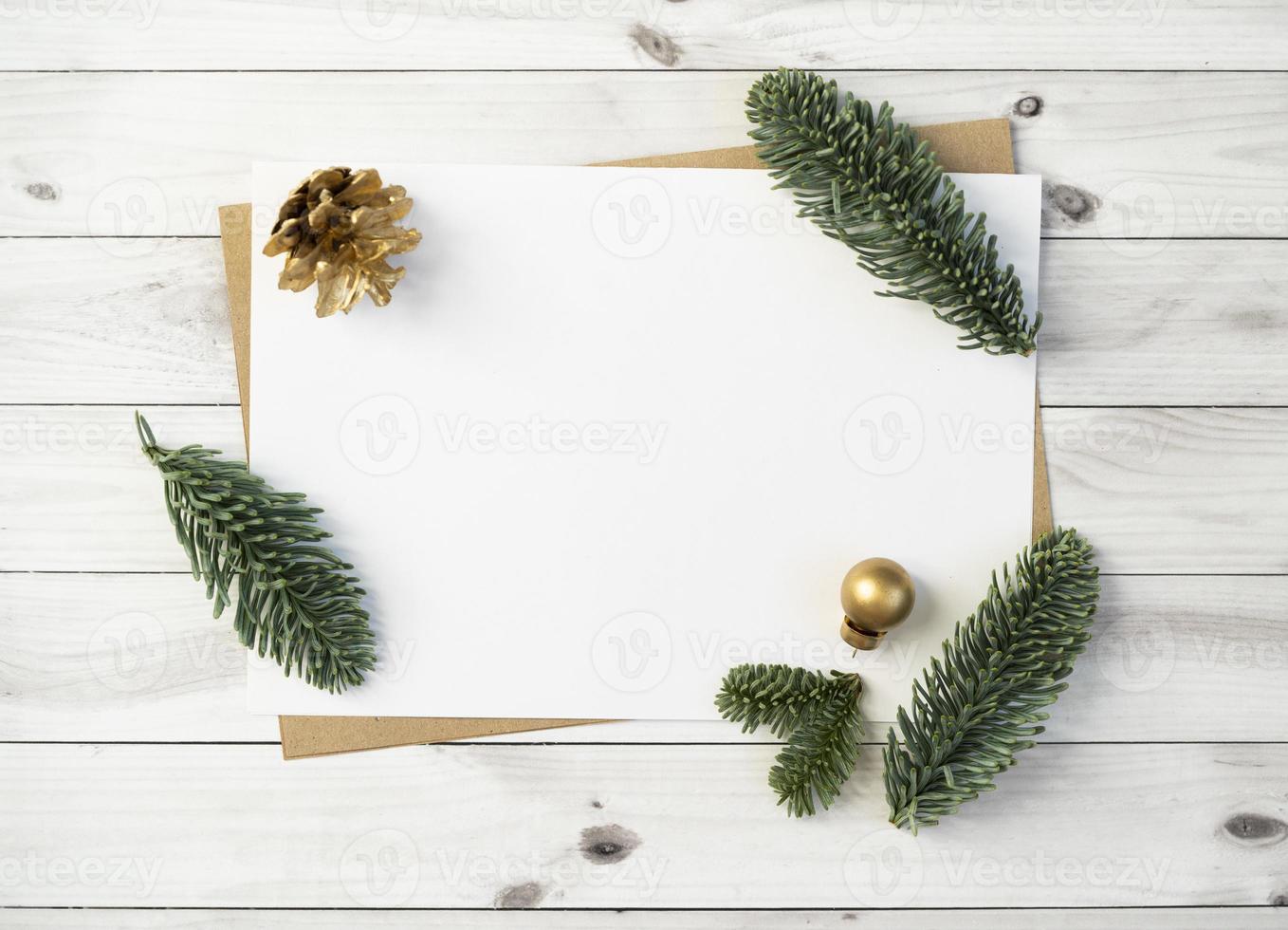 Mockup for a letter or a Christmas invitation with gold fir cone photo