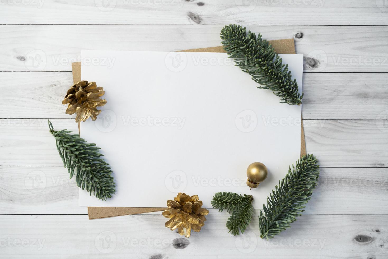 Mockup for a letter or a Christmas invitation with gold fir cone photo