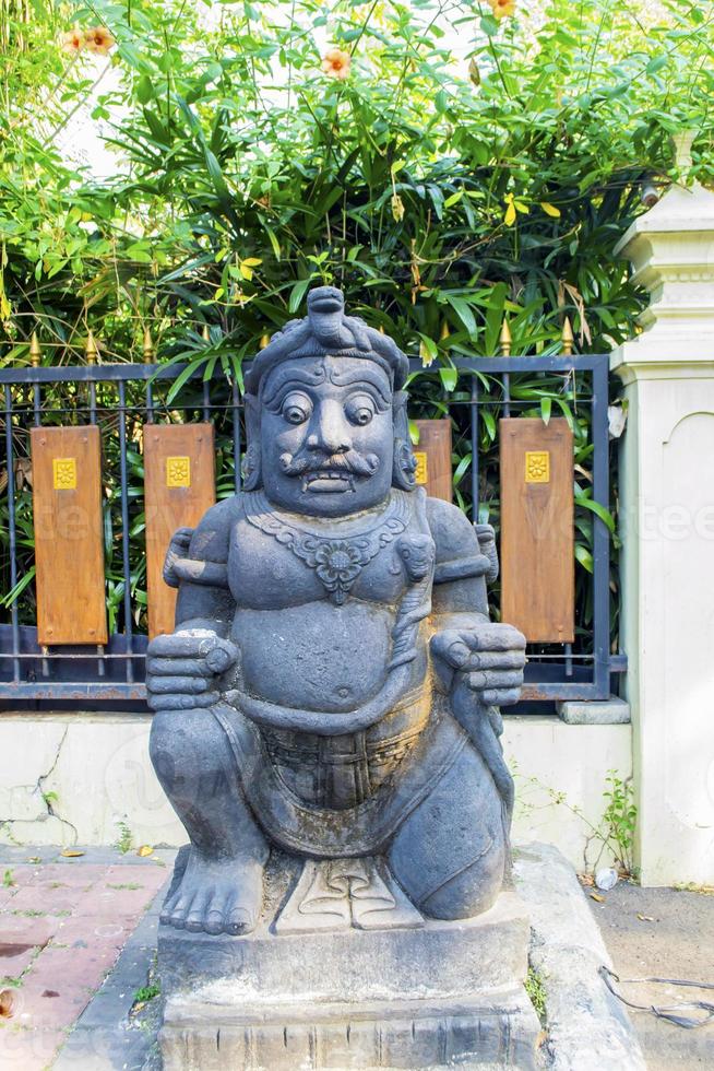 a typical Balinese statue is displayed in front of the house photo