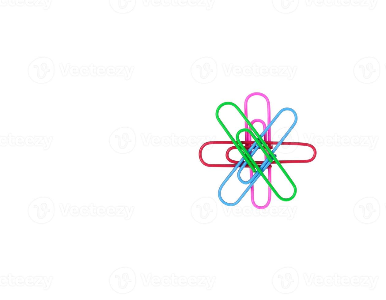 Series of colorful paper clips in the form of a flower on white background. Decorative paper clips in pink, green, red and blue colors photo