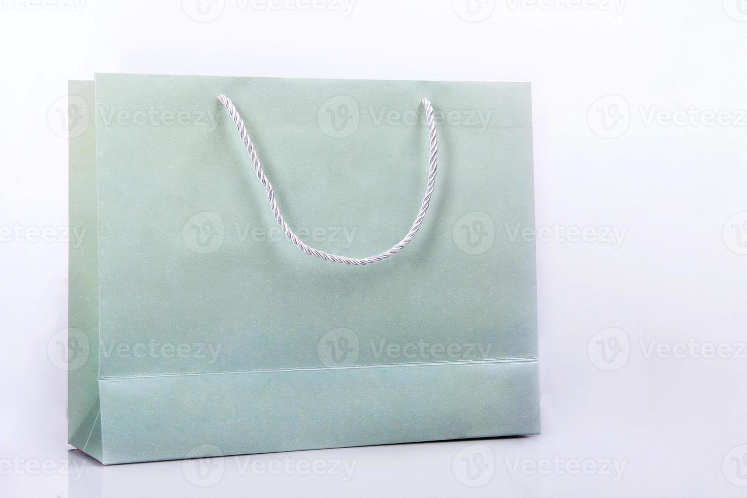 Plain green paper bag. Paper bags for products or merchandise with copy space on white background photo