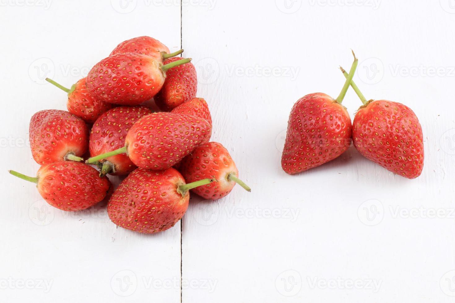 Fresh strawberries on a white wooden background photo