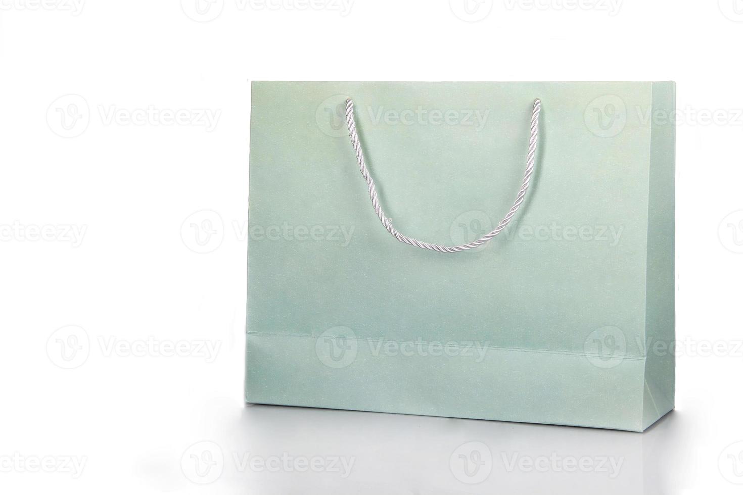 Plain green paper bag. Paper bags for mockup products or merchandise with copy space on white background photo