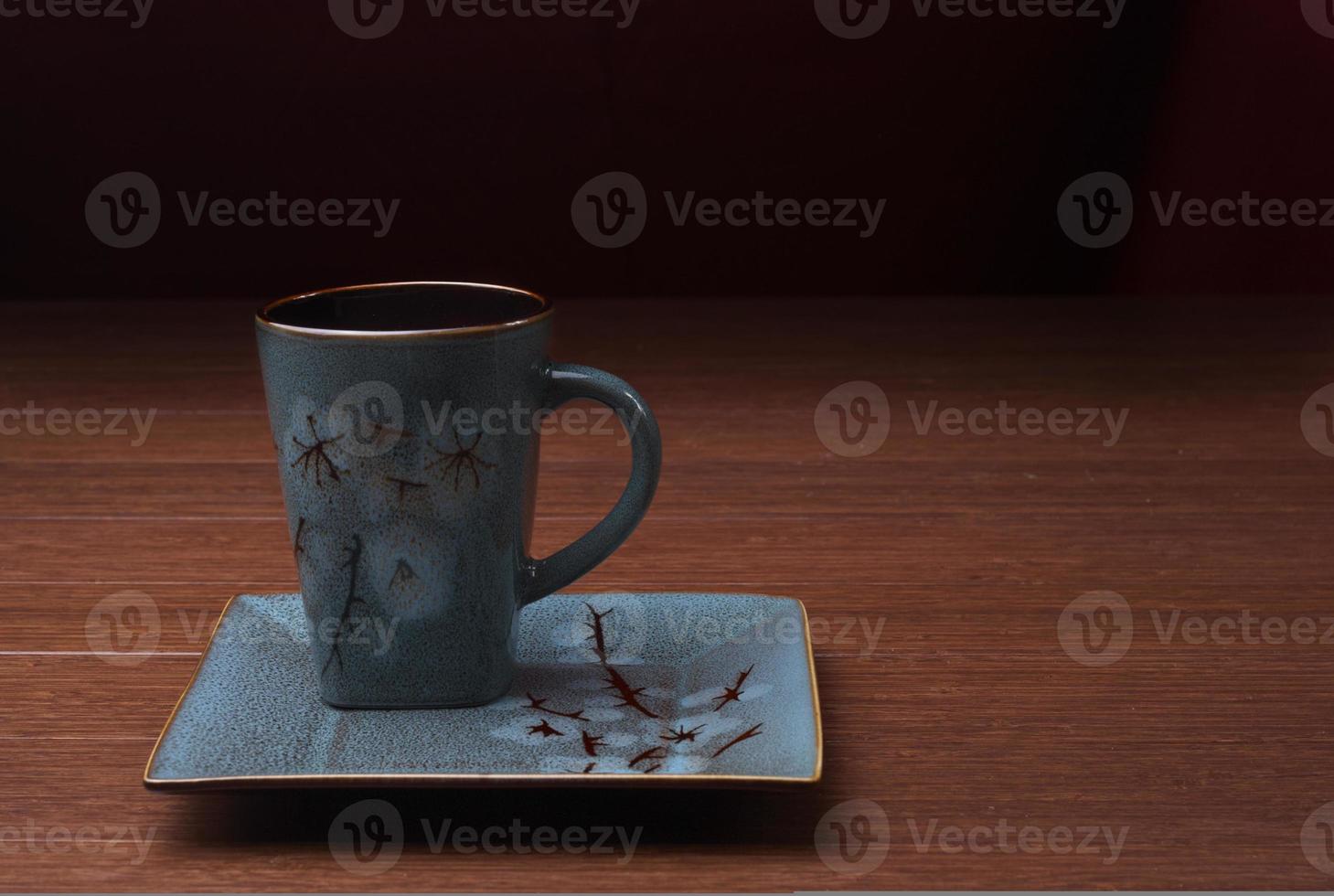 una taza de café sobre un fondo oscuro foto