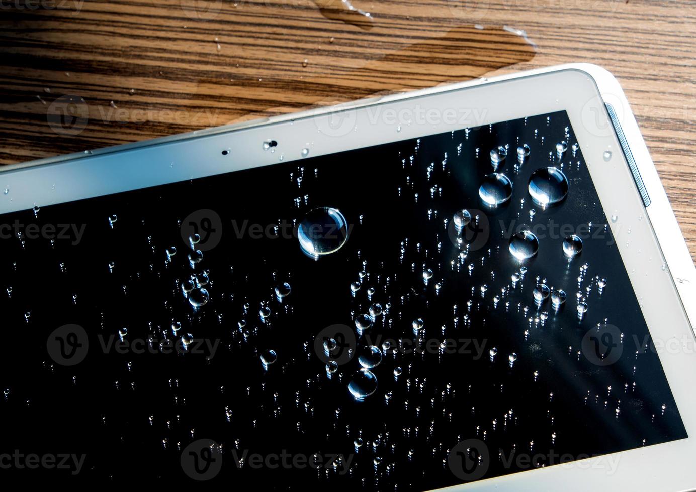 Drops of water on tablet screen photo