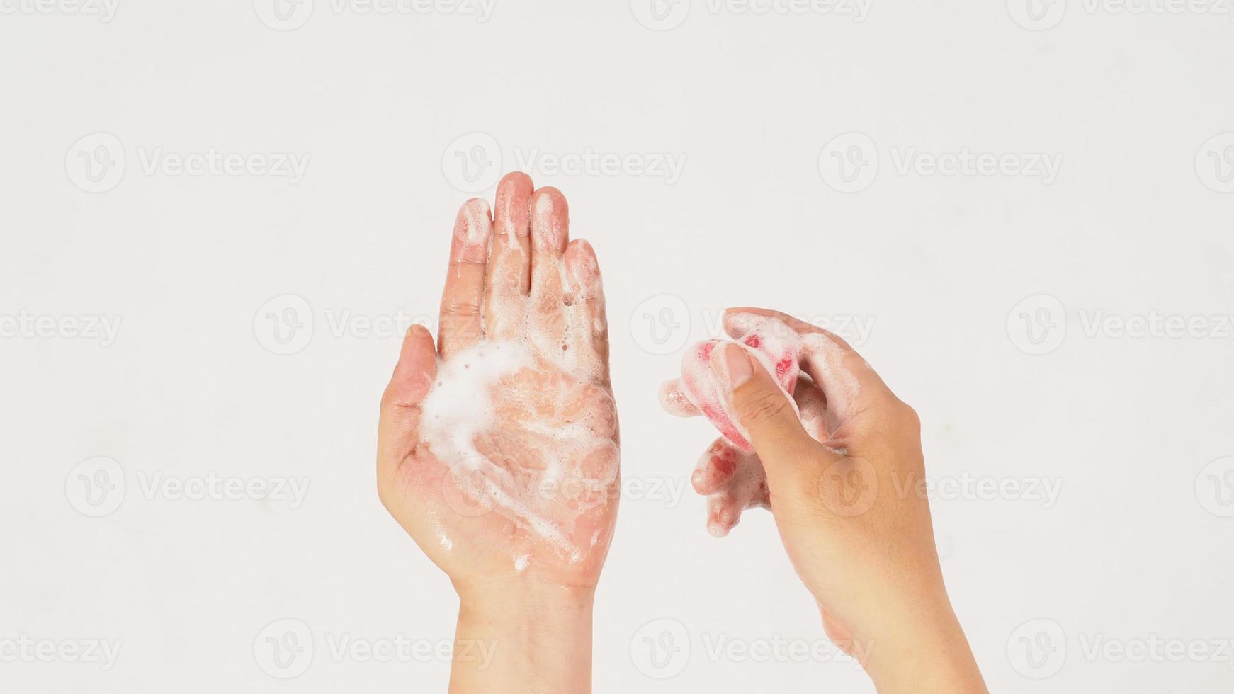 Hands washing with foaming and pink soap on white background. Studio shot photo