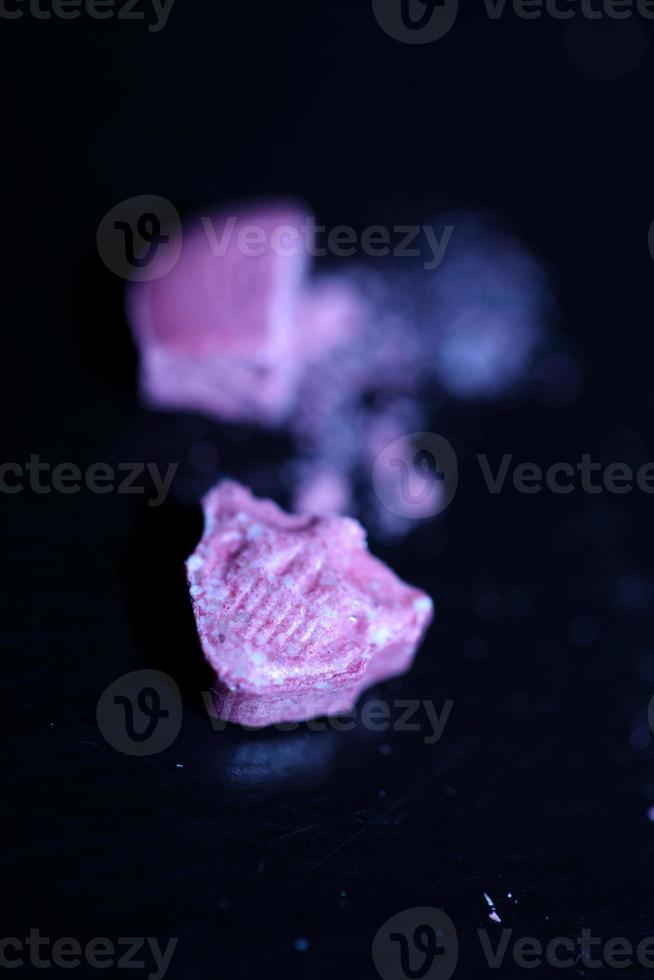 Pink skull ecstasy pill close up background high quality print purple army dope narcotics substance high dose psychedelic way of life photo