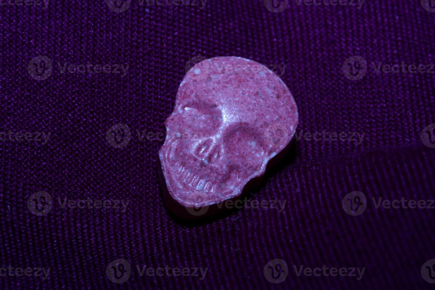 Pink skull ecstasy pill close up background high quality print purple army dope narcotics substance high dose psychedelic way of life photo