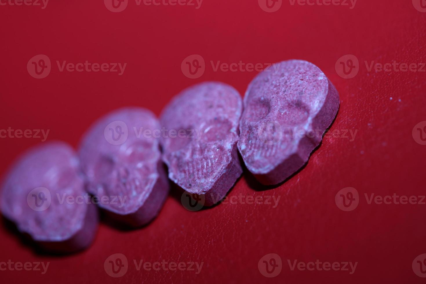 Pink skull ecstasy pill close up background high quality print purple army dope narcotics substance high dose psychedelic way of life photo
